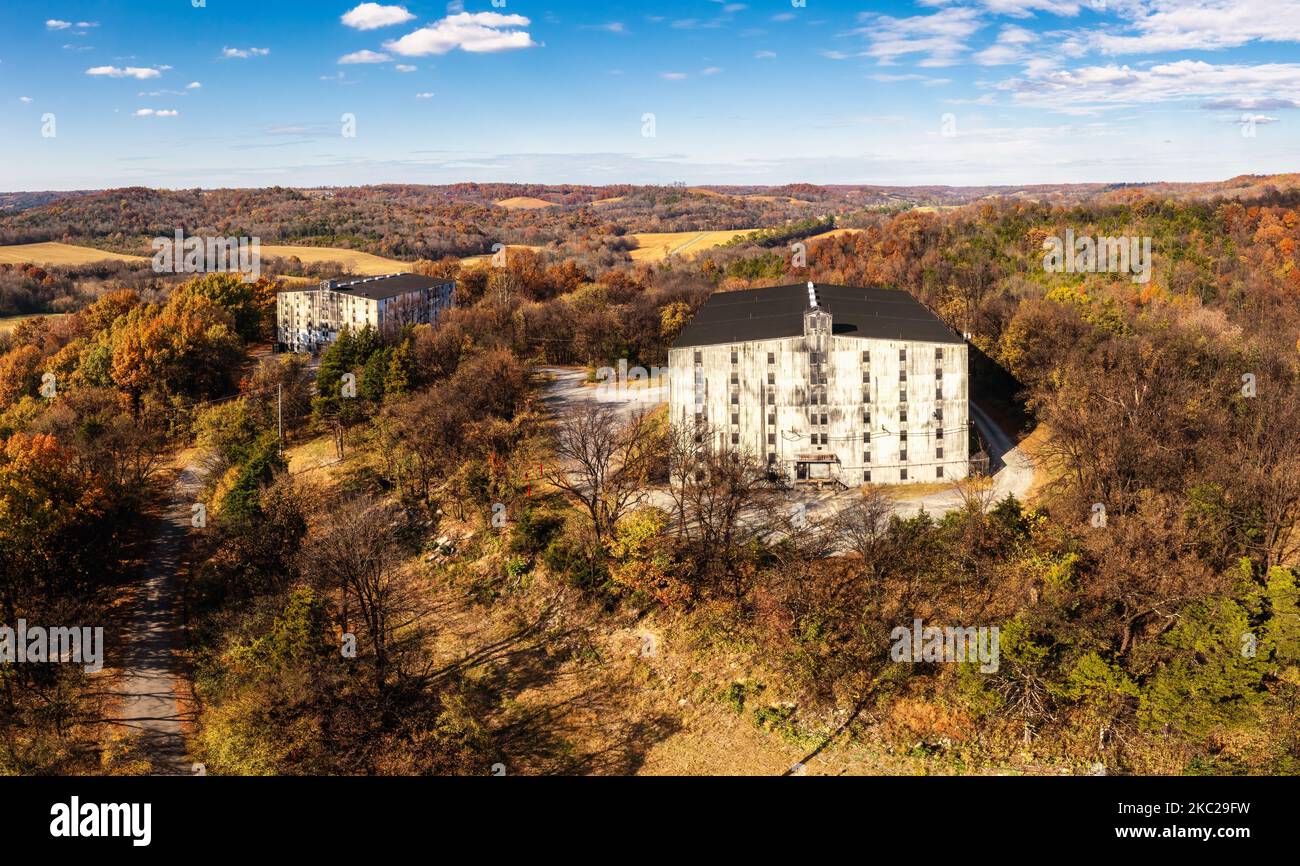 Aerial View of two rackhouses or rickhouses storing barrels of bourbon whiskey ageing on a hill. Autumn colorful fall foliage panorama in Lynchburg Te Stock Photo
