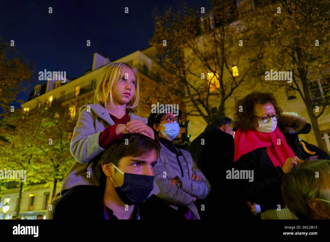 People gathered on the Place de la Sorbonne in Paris on October 21, 2020, to watch a live broadcast on a giant screen of the national tribute to the french teacher Samuel Paty, a teacher at the College du Bois d'Aulne in Conflans-Sainte-Honorine, who was beheaded by an islamist. Samuel Paty was killed for having shown caricatures of the Prophet Mohammed published by Charlie Hebdo to his pupils during a course on freedom of expression. (Photo by Adnan Farzat/NurPhoto) Stock Photo