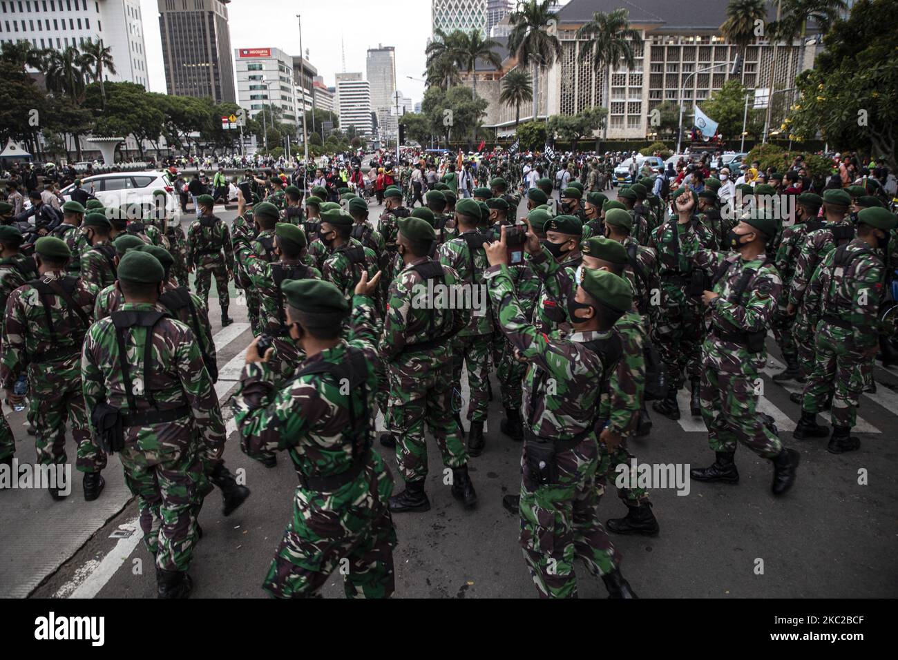 Millitary Personnel securing the area after demonstrant leave the area during a demonstration against the Omnibus law in Jakarta, Indonesia, on October 22, 2020. Thousands of Labour and Students held demonstration at Merdeka Barat Street Central Jakarta, Indonesia to protest omnibus law legallization. (Photo by Donal Husni/NurPhoto) Stock Photo