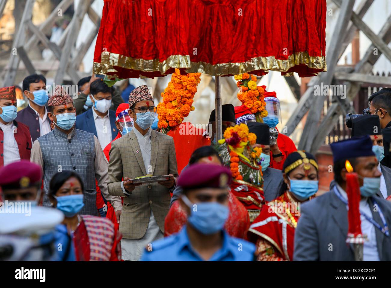 Nepali Hindu devotees carry plants used for blessings as they attend