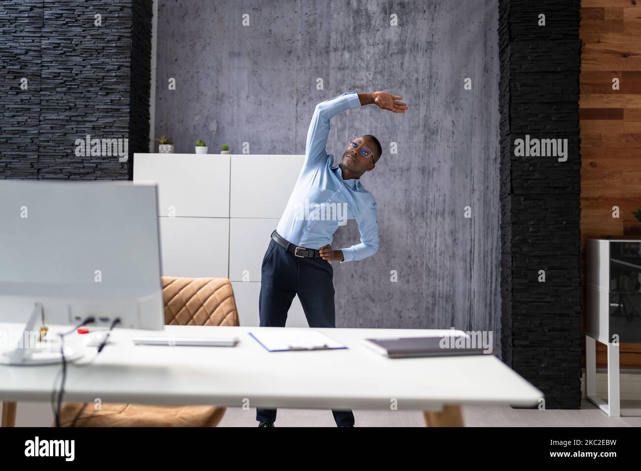Arms Stretch Exercise Standing Near Desk In Office Stock Photo Alamy