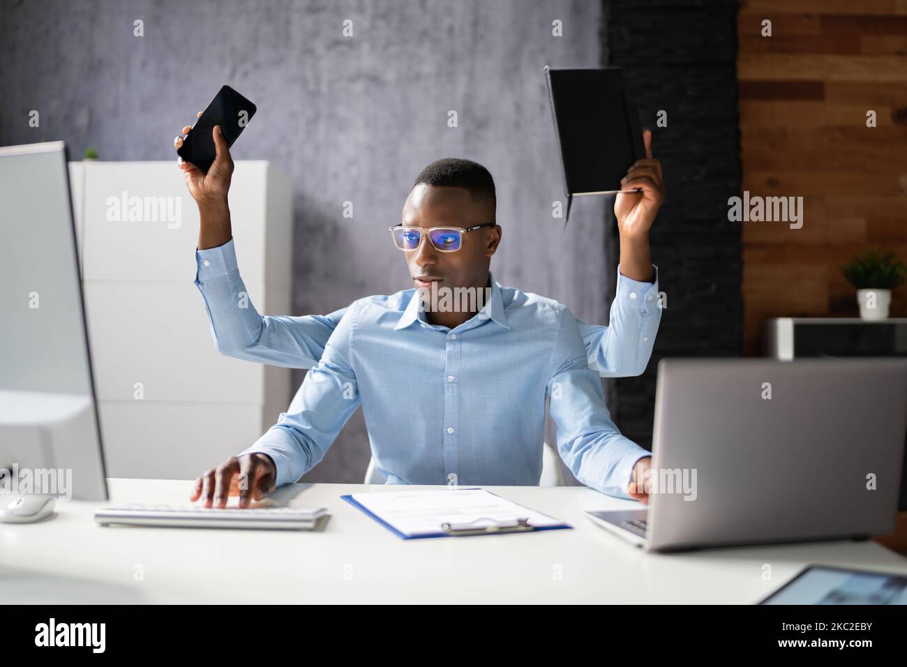 Multitasking Workload Of Happy Busy Man Worker In Office Stock Photo