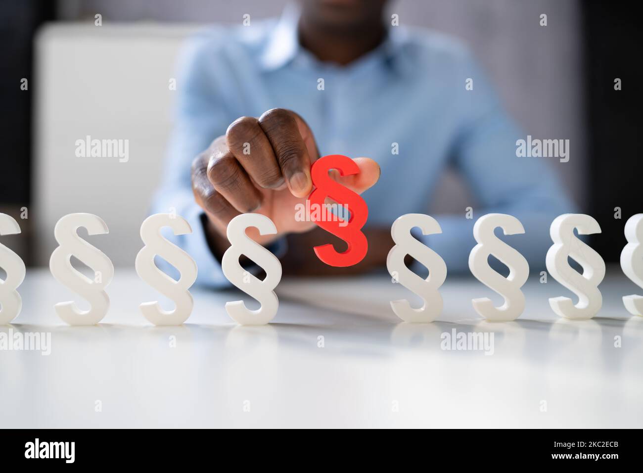Businessperson's Hand Holding Paragraph Symbol. Legal Court Stock Photo