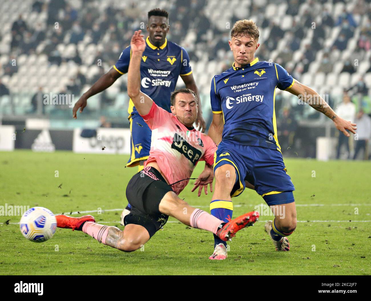 Matteo Lovato of Hellas Verona FC competes for the ball with Aaron