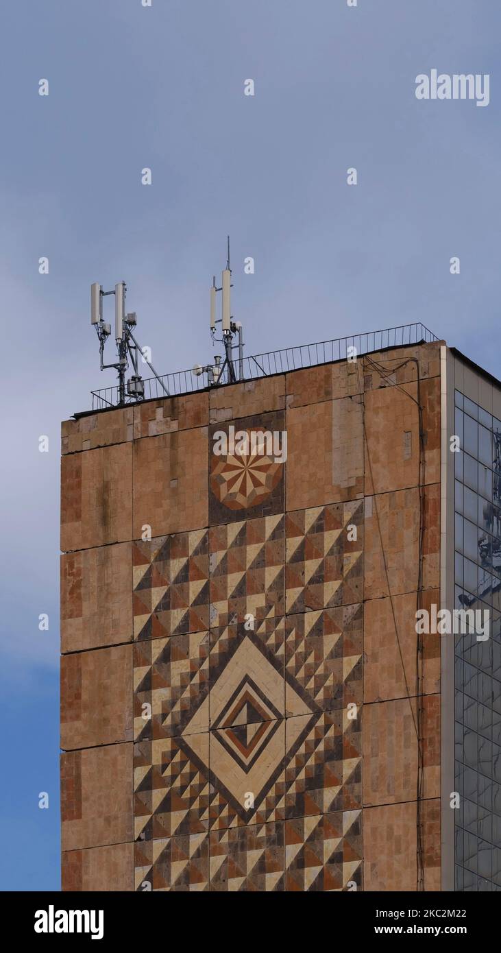 A vertical shot of a brown brick building with intricate patterns on ...