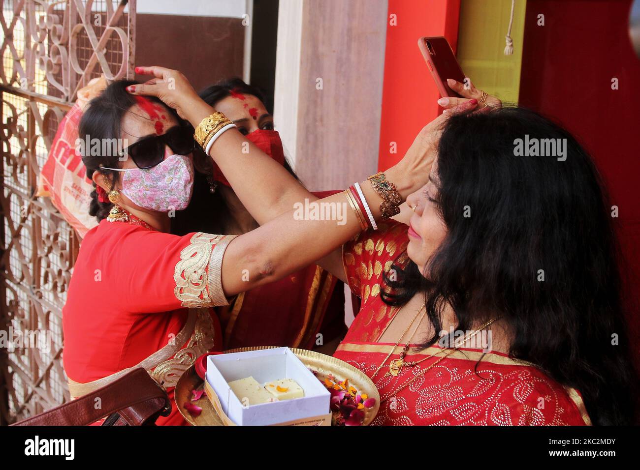 Hindu married women during 'Sindur Khela' (applying vermilion) on the occasion of â€˜Bijoya Dashamiâ€™ at a Durga Puja pandal 'Durgabari' in Jaipur , Rajasthan,India , Monday , Oct 26,2020. (Photo by Vishal Bhatnagar/NurPhoto) Stock Photo