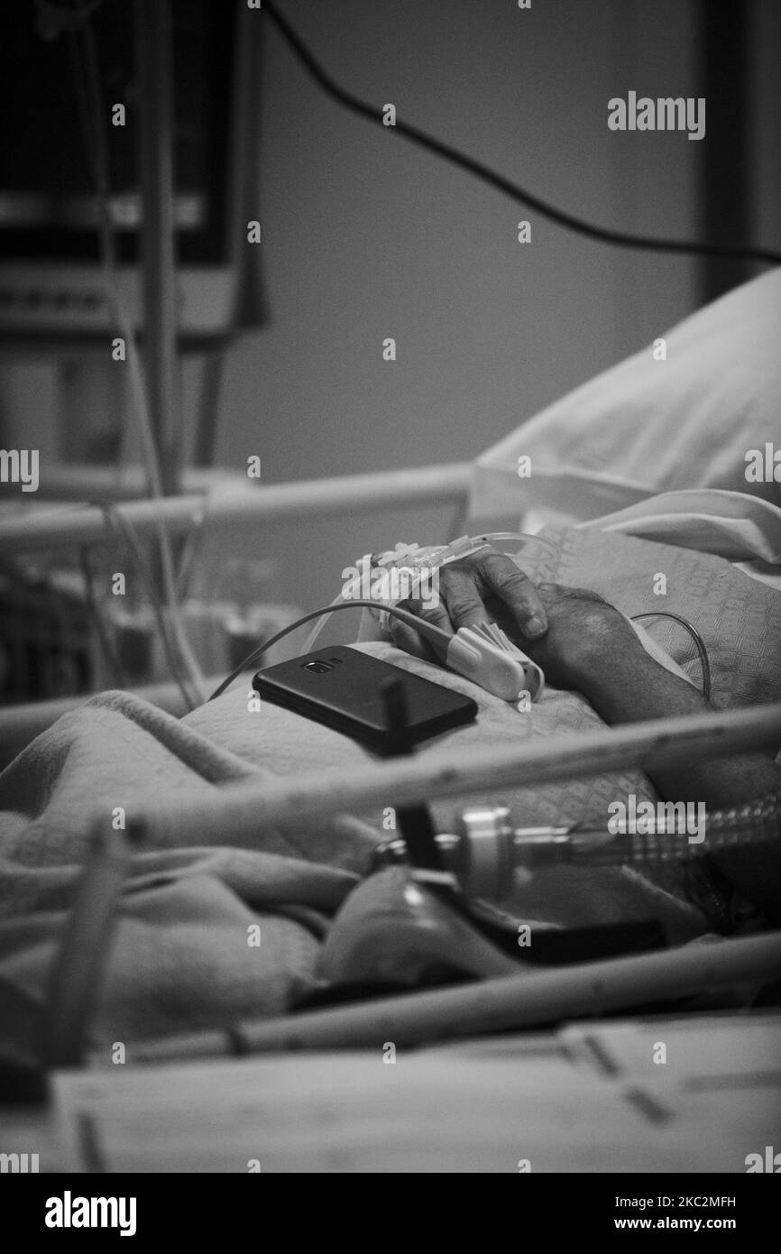 (EDITOR'S NOTE: IMAGE HAS BEEN CONVERTED TO BLACK AND WHITE) A patient lies in a bed in the COVID level-3, Intensive Care Unit (ICU) for novel coronavirus, COVID-19 cases, at the Casal Palocco hospital, near Rome on October 26, 2020. .According to Ministry of Health there has been 21,273 infections from Covid-19 in the last 24 hours out of 161,880 tampons carried out. 128 deaths and 80 additional patients admitted to intensive care units. (Photo by Christian Minelli/NurPhoto) Stock Photo