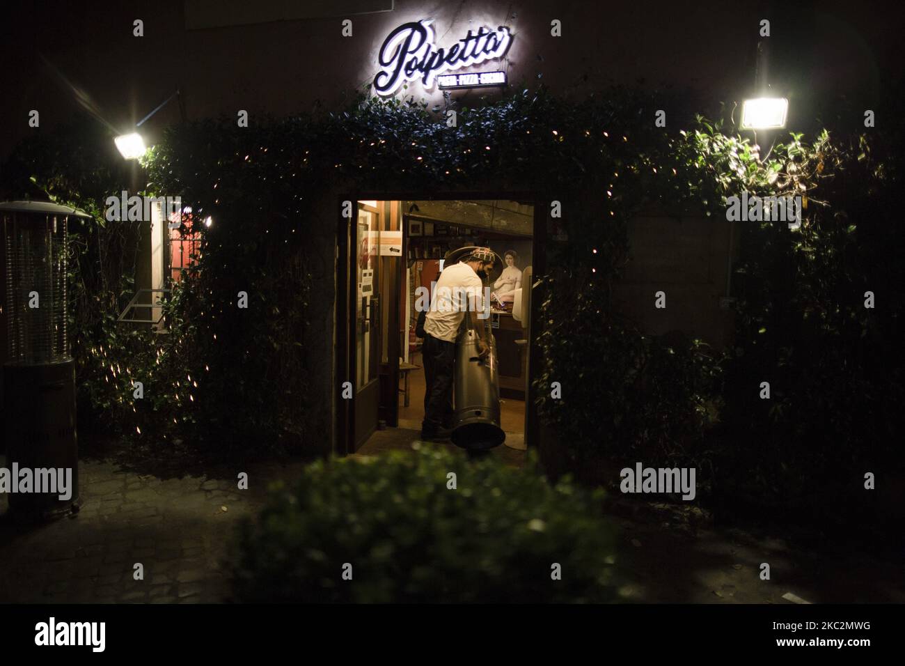 Staffers close a restaurant in Trastevere district as Italy is facing a