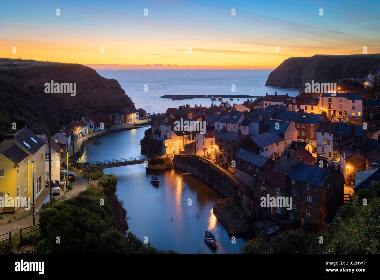 Dawn breaking over Staithes Harbour North Yorkshire England Stock Photo