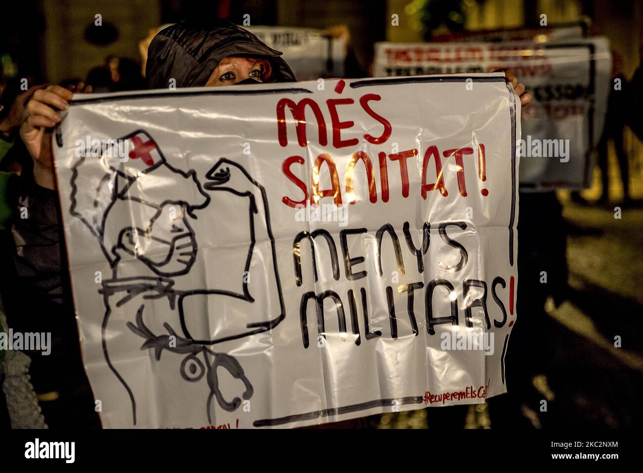 Members of the People's Unity Candidacy (CUP), the Catalan left-wing pro-independence party, demonstrate against the curfew, which they consider to be a militarisation of society and in favour of public health to fight the pandemic of the Covid-19 Coronavirus during the second night of curfew. In Barcelona, Catalonia, Spain on 26 October 2020. (Photo by Albert Llop/NurPhoto) Stock Photo