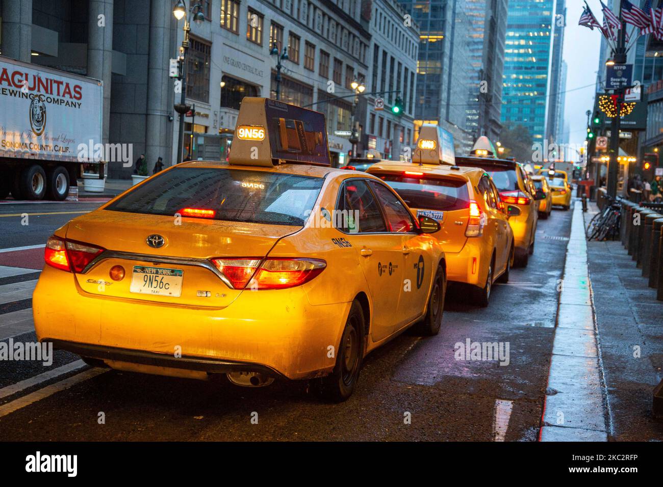 Iconic yellow taxi stationary inline queued and moving on the streets
