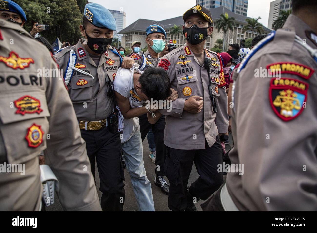 Jakarta, Indonesia, 28 October 2020 : Policemen arrested a pickpocket after caught stealing demonstrant smart phone. Thousands of students held demonstration near Jakarta palace at merdeka street to protest the legallization of Omnibus Law. (Photo by Donal Husni/NurPhoto) Stock Photo
