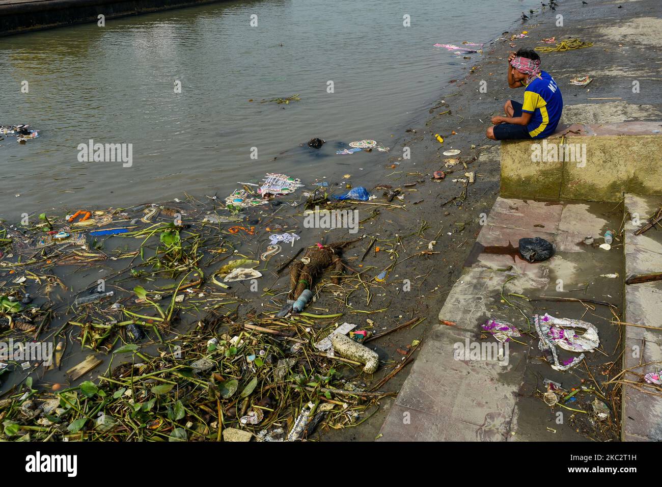 Ganges Pollution Rituals A municipal worker takes rest after his shift in front of debris filled ...