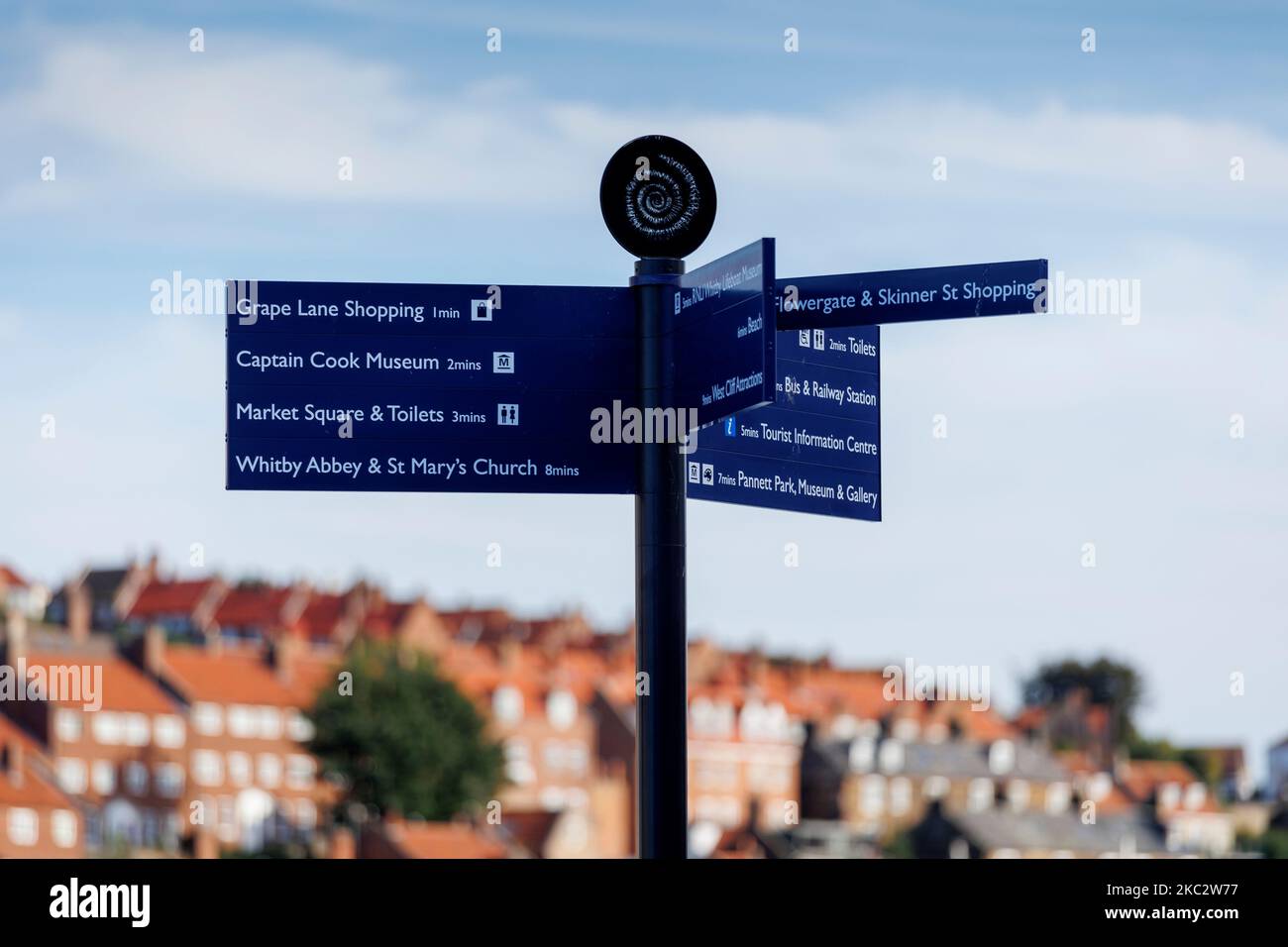 Direction signpost Whitby North Yorkshire England against a blue sky Stock Photo