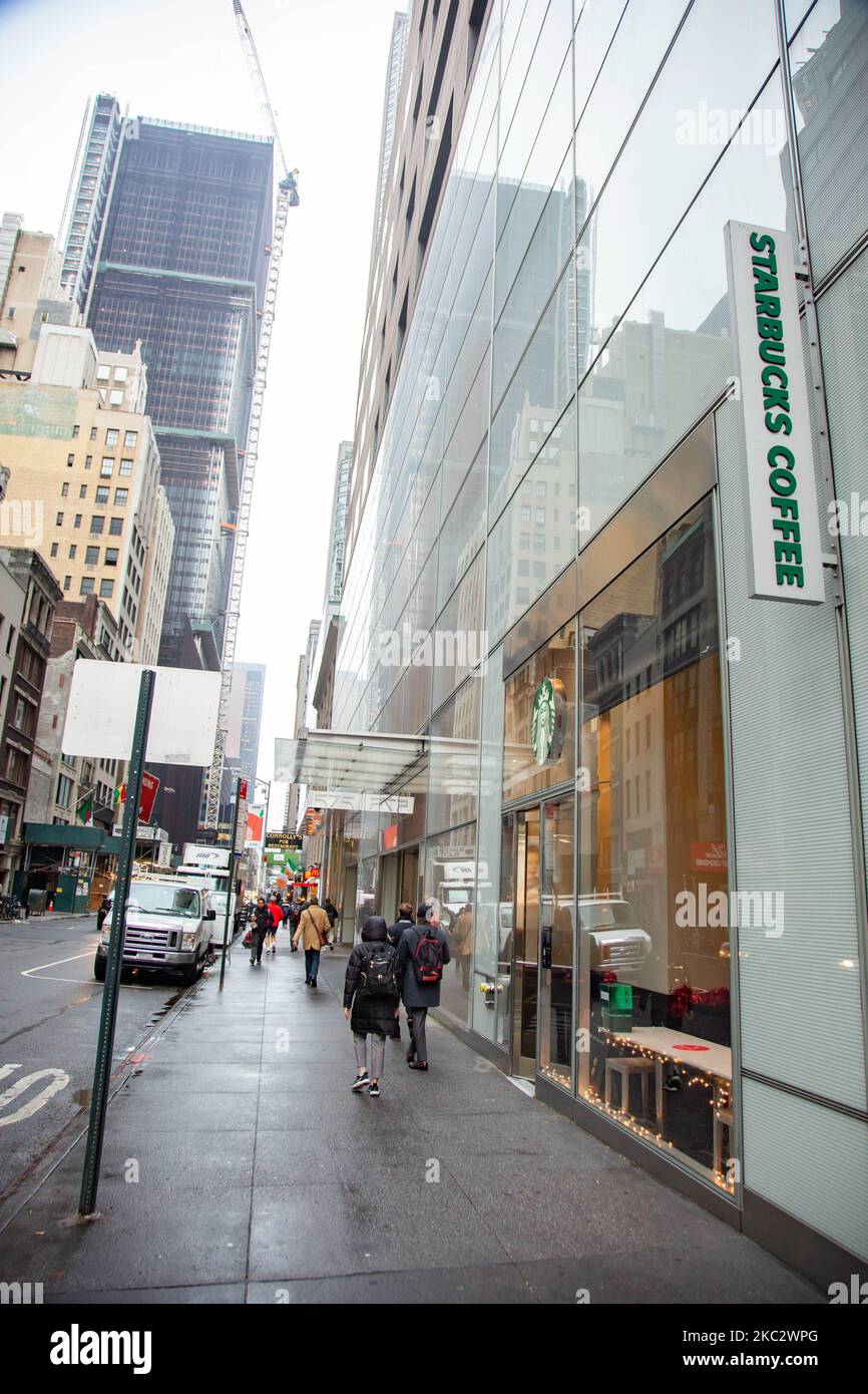 A store front of a Starbucks Coffee shop located in Midtown Manhattan with people walking by and the traffic and skyscrapper visible. Starbucks Corporation is the world's largest coffeehouse chain, an American multinational cafe chain with headquarters in Seattle Washington. NYC, United States of America on February 2020 (Photo by Nicolas Economou/NurPhoto) Stock Photo