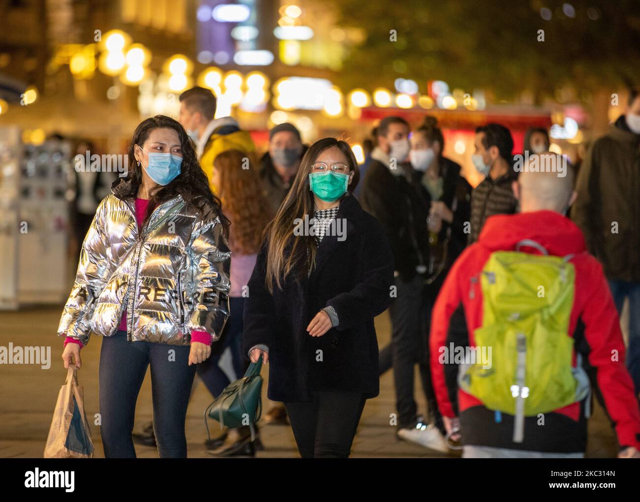 People wearing masks in the pedestrian zone in Munich, Germany on