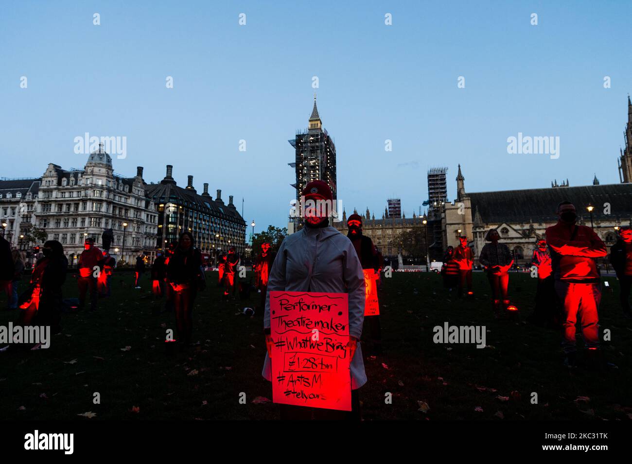 A socially distanced line of #WeMakeEvents supporters and technical crew congregate in the Parliament Square to take their bow following the week’s creative activations on October 31, 2020 in London, United Kingdom. The aim is to showcase the breadth of live events and the technical supply chain that support them, and that live events need government policies in place to help people to return to work and further financial aid until everyone can return. The protest has been organised by We Stand As One #WeMakeEvents who are calling for meaningful support from the Government until the industry i Stock Photo