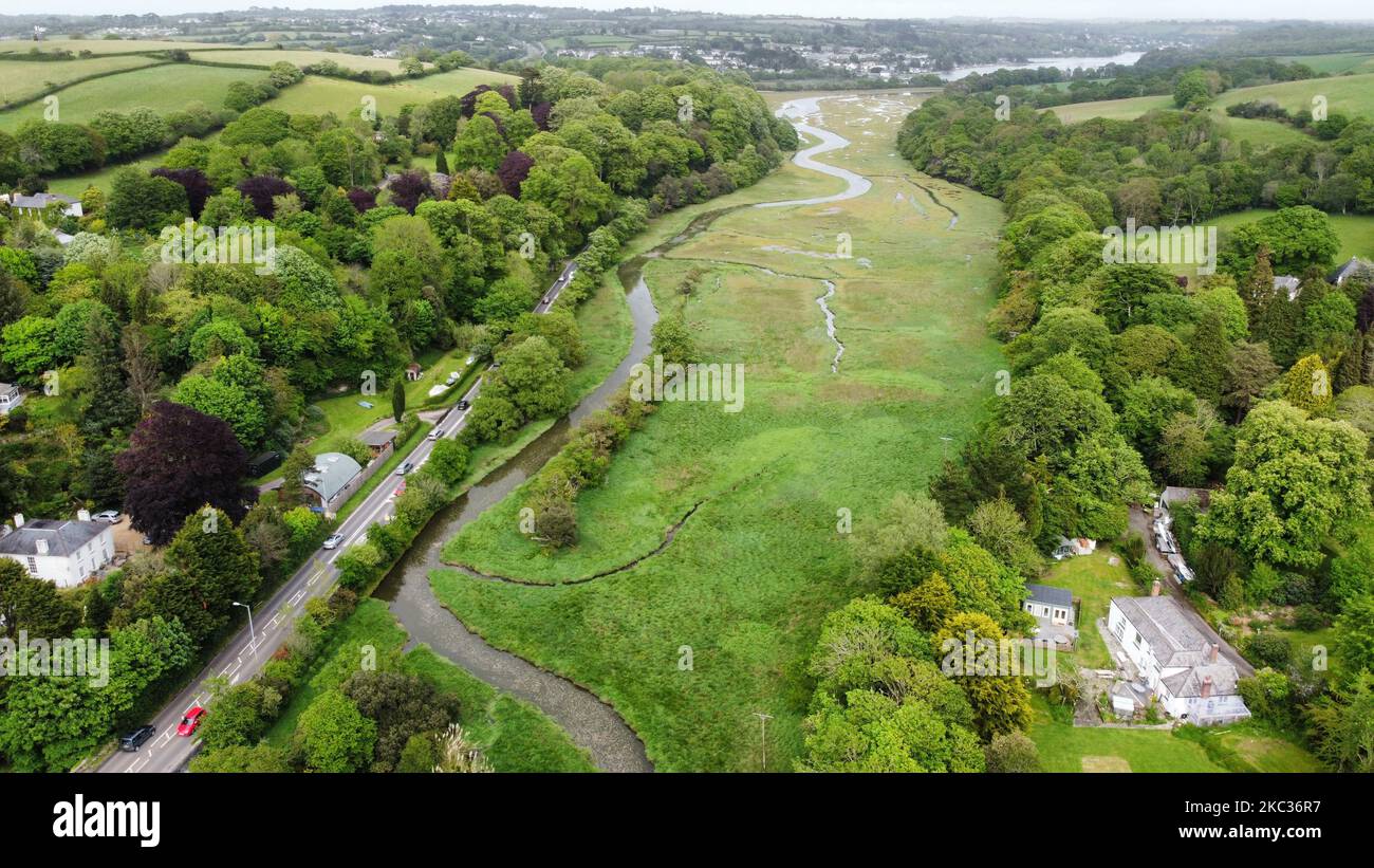 An aerial view of a river streaming through a town and green valley ...