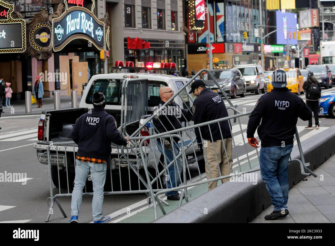 NYPD Officials are seen piling metal barricades to block roads in
