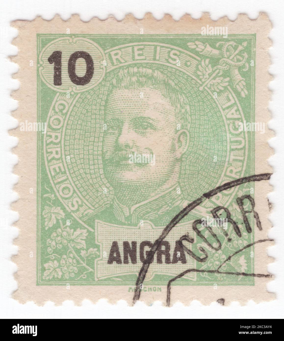 ANGRA - 1897: An 10 reis yellow-green postage stamp showing portrait of Dom Carlos I, known as the Diplomat, the Martyr, and the Oceanographer, among many other names, was the King of Portugal from 1889 until his assassination in 1908 Stock Photo