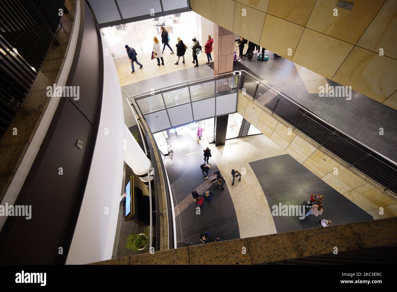 People wait in line at a fashion ratailer at a shopping mall in Warsaw, Poland on November 6, 2020. A partial lockdown will be imposed for two weeks starting on Saturday across the entire country. Daily cases of coronavirus infections have kept rising in the last two weeks despite restaurants and bars having been closed in addition to implementing distance learning for most grades in schools. To prevent a collapse of the overburdened healthcare system the Prime Minister's office announced new restrictions including the closing of shopping malls, hotels for tourists and mandatory distance learn Stock Photo