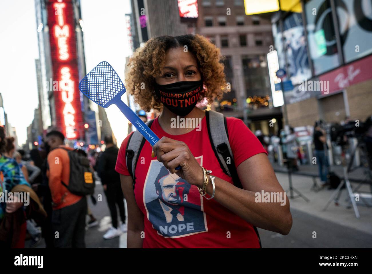 A woman poses for a portrait with a fly swatter in Times Square on ...