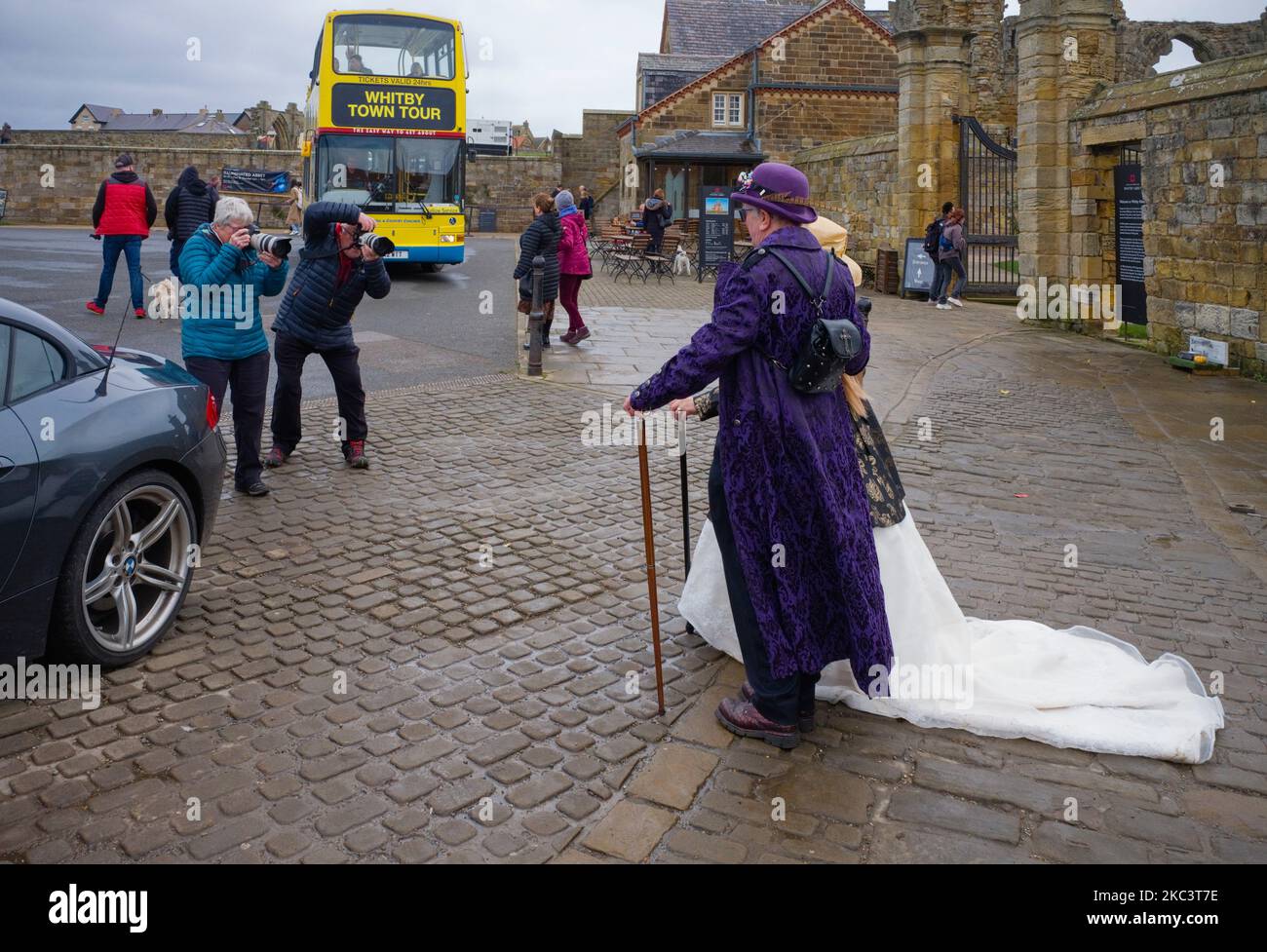 A couple of goth dressed people pose for amateur photographers during goth weekend at Whitby Stock Photo