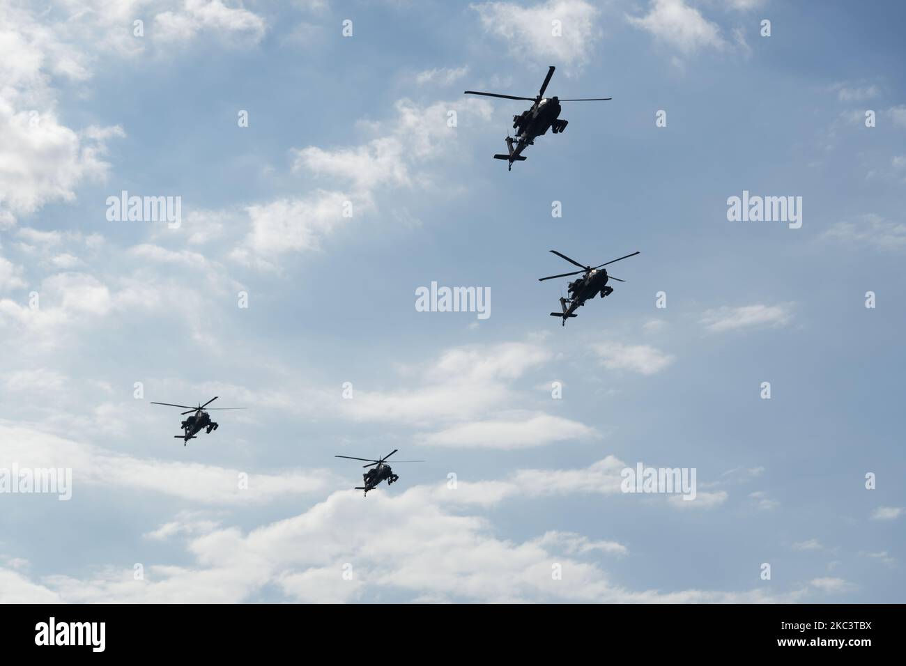 Boeing AH-64 attack helicopters on formation during air show. Greek Air Force Apache flying during October National Oxi Day parade Thessaloniki Greece Stock Photo