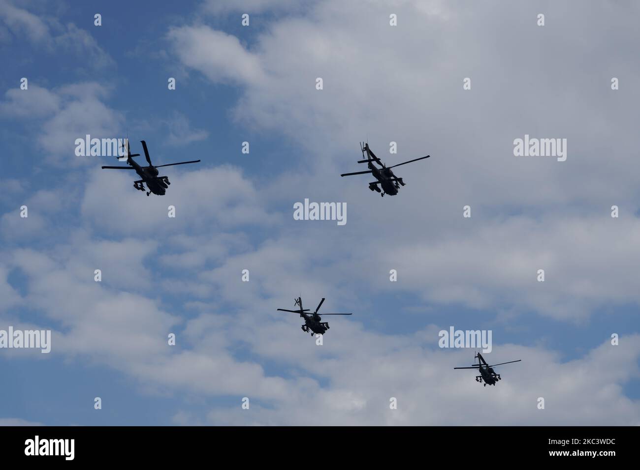 Boeing AH-64 attack helicopters on formation during air show. Greek Air Force Apache flying during October National Oxi Day parade Thessaloniki Greece Stock Photo