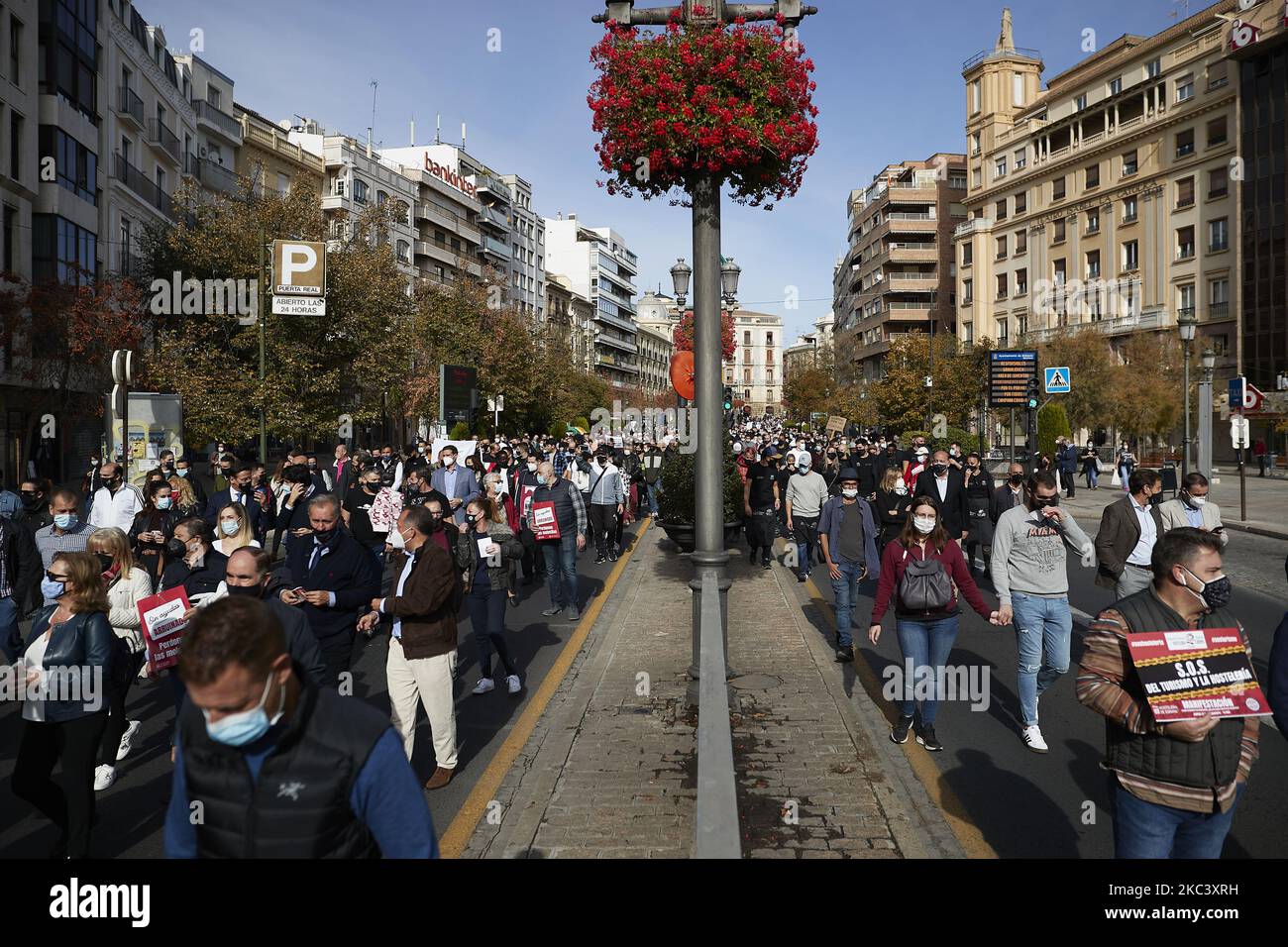 People march during a demonstration of hostelry workers asking for help in their businesses against the latest virus restrictions on November 12, 2020 in Granada, Spain. Since November 10 bars and restaurants have been closed in Granada, all non-essentials hostelry businesses are obligated to close except to serve food and drink for take-away and delivery only. Hostelry workers like waiters, chefs and restaurants owners demonstrate to ask for help in their businesses after the measures imposed by the Andalusian regional government. (Photo by Fermin Rodriguez/NurPhoto) Stock Photo