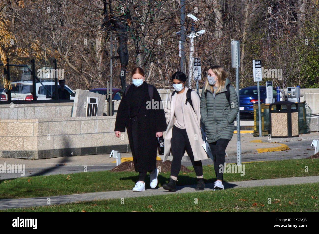People wearing face masks as they walk along the street during the novel coronavirus (COVID-19) pandemic in Toronto, Ontario, Canada on November 12, 2020. Ontario reported 1,575 new COVID-19 cases today and 18 more deaths, setting a new single-day record for daily cases reported in a 24-hour period since the start of the pandemic. New modeling projections warn that Ontario could see 6,500 daily cases of COVID-19 by mid-December. The projections also suggest that the number of COVID-19 patients in intensive care units will exceed the 150 threshold within two weeks, overwhelming some hospitals a Stock Photo