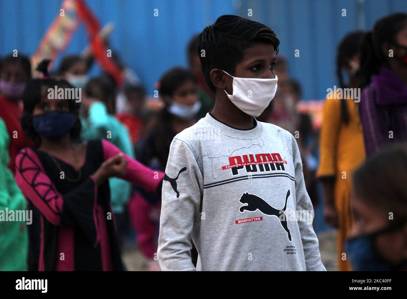 Children of Pakistani Hindu refugees stand following social distancing norms during a visit by Bharatiya Janta Party (BJP) Yuva Morcha President Tejasvi Surya on the eve of Diwali, the Hindu festival of lights, at Adarsh Nagar on November 13, 2020 in New Delhi, India. (Photo by Mayank Makhija/NurPhoto) Stock Photo