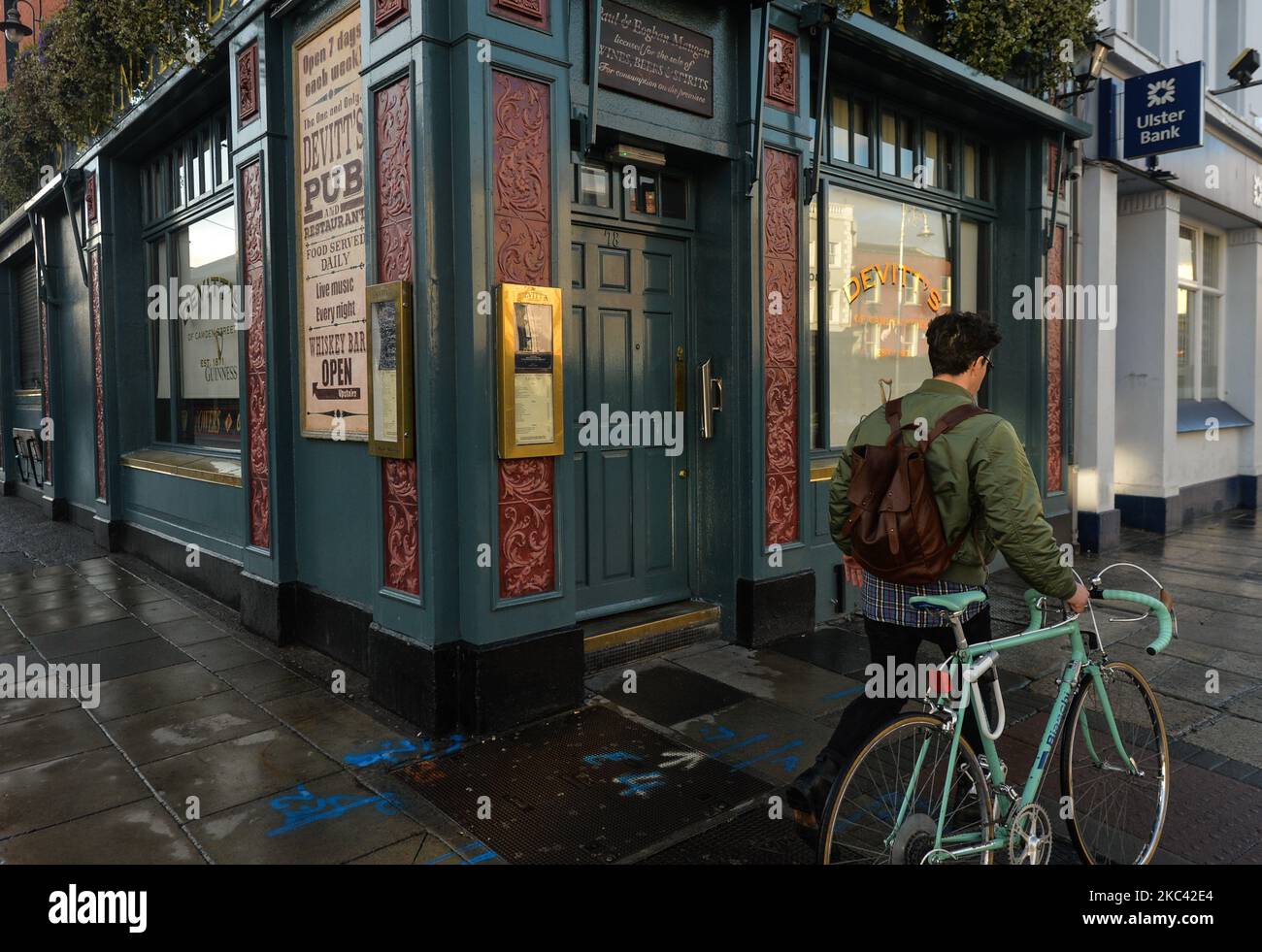 A cyclist passes by a closed Devitt's Pub in the center of Dublin. On