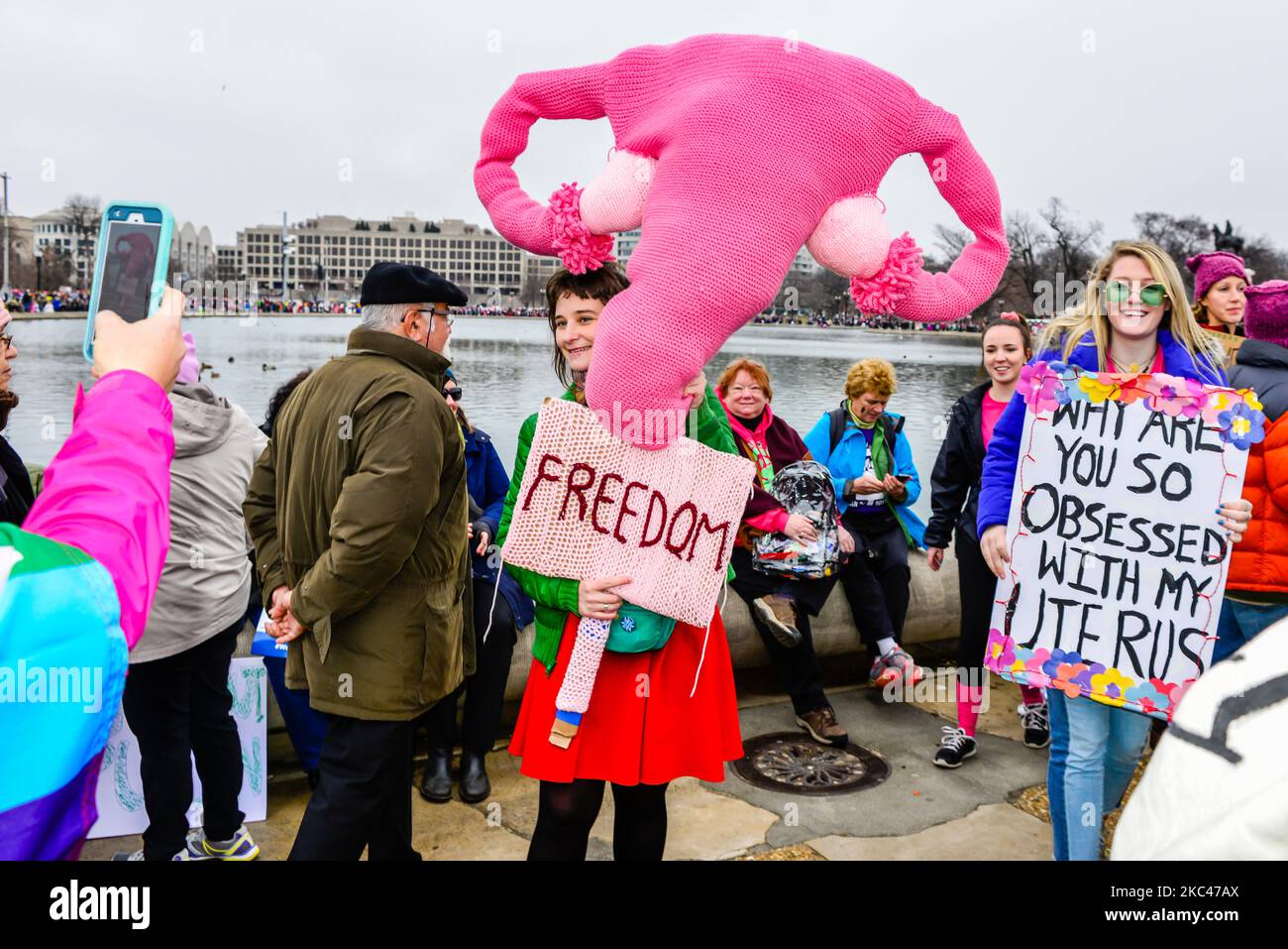 Protest by woman holding big knitted pink uterus  with Fallopian tubes, with sign for Freedom, Fight for Abortion rights, Washington DC Stock Photo