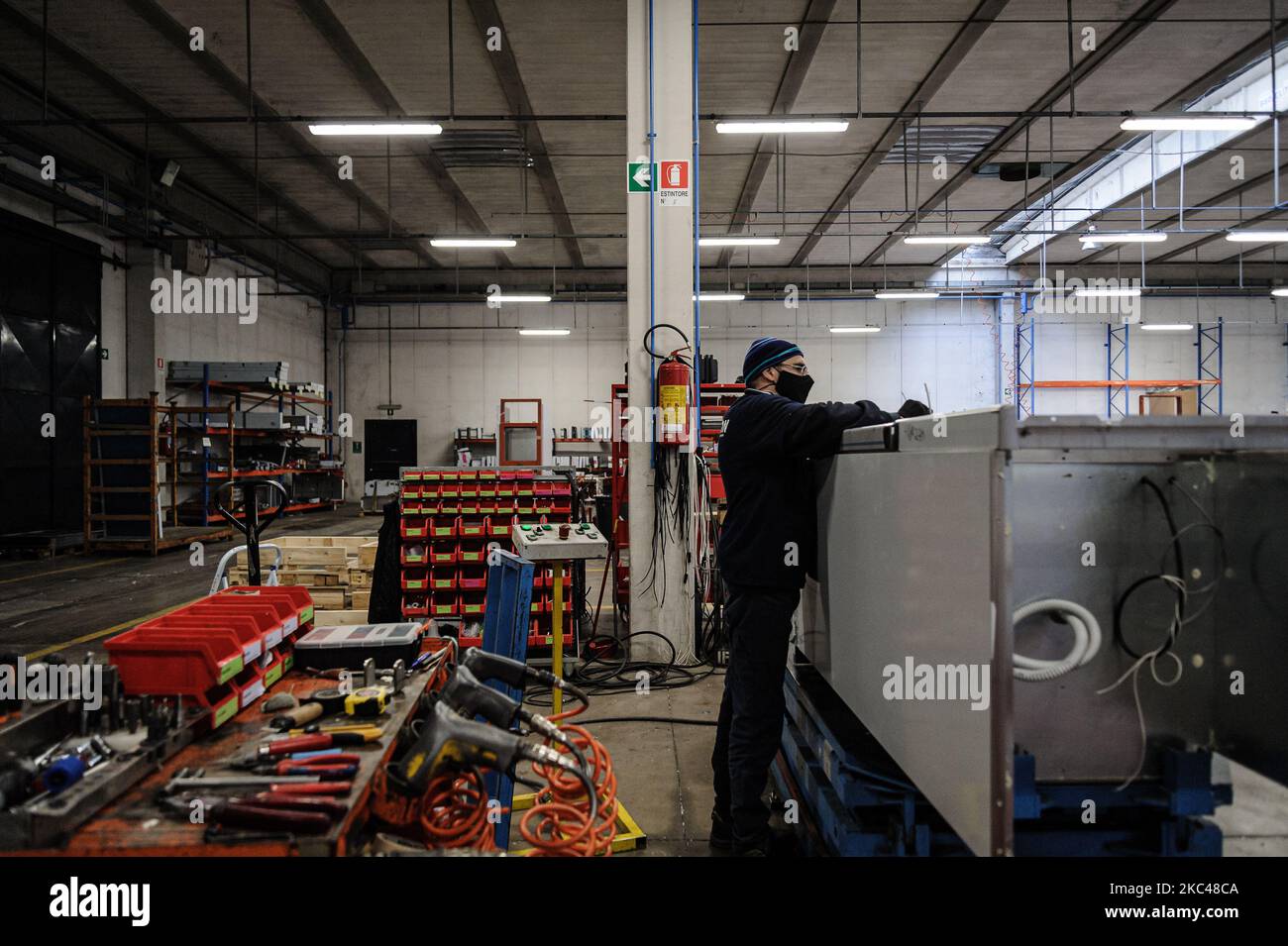 A worker of the Italian company Desmon assembling a part of a