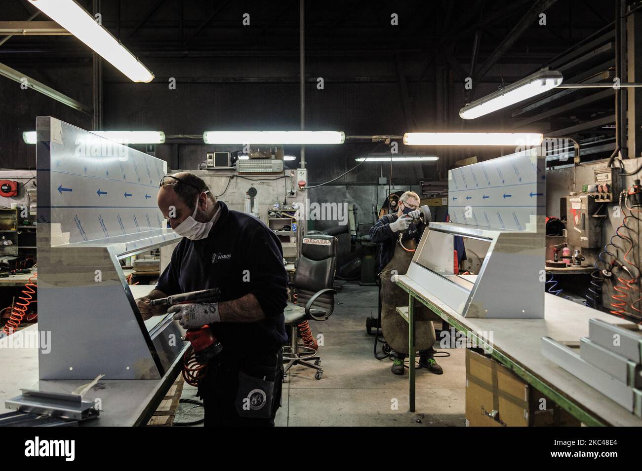 A worker of the Italian company Desmon assembling a part of a