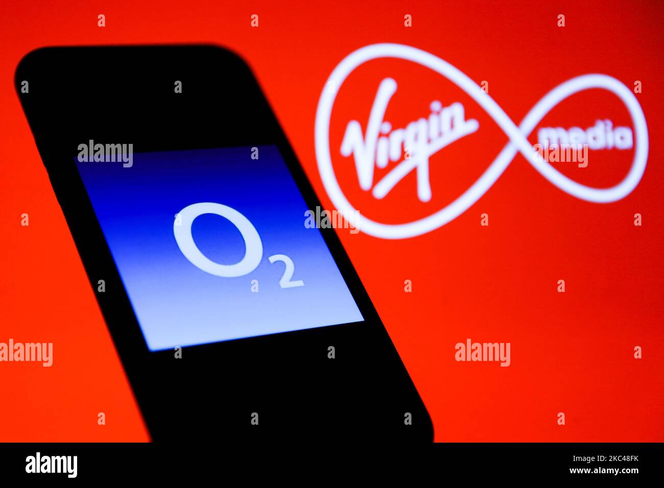 O2 logo is seen displayed on a phone screen with Virgin Media logo displayed on the background in this illustration photo taken in Poland on November 19, 2020. (Photo by Jakub Porzycki/NurPhoto) Stock Photo