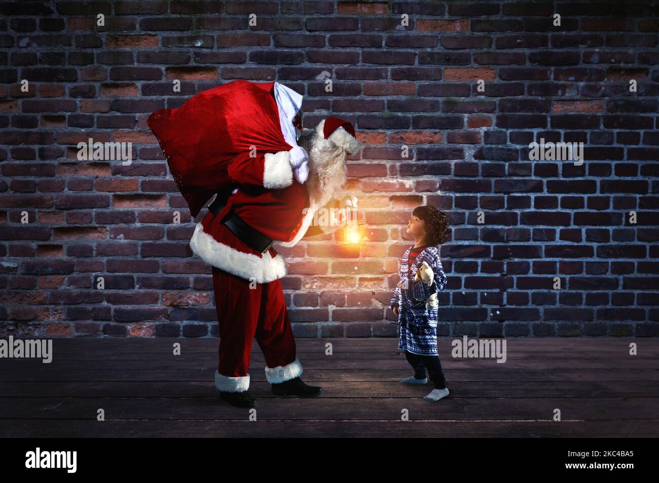 Santa Claus is giving a present for Christmas to a little boy Stock Photo