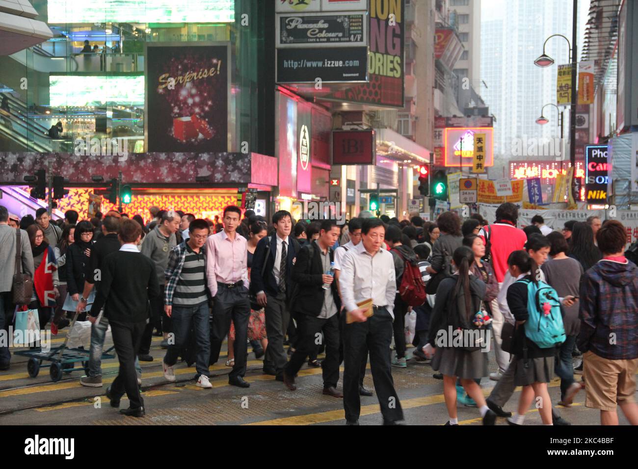 A crowded busy street with people walking around and glowing lights in ...