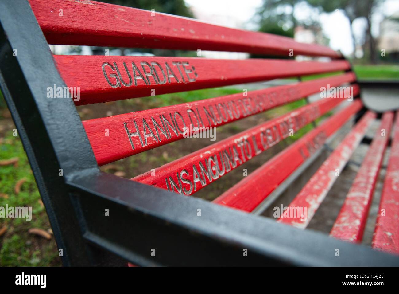 A view of a ''red bench'' with an aphorism in L'Aquila (Italy) on