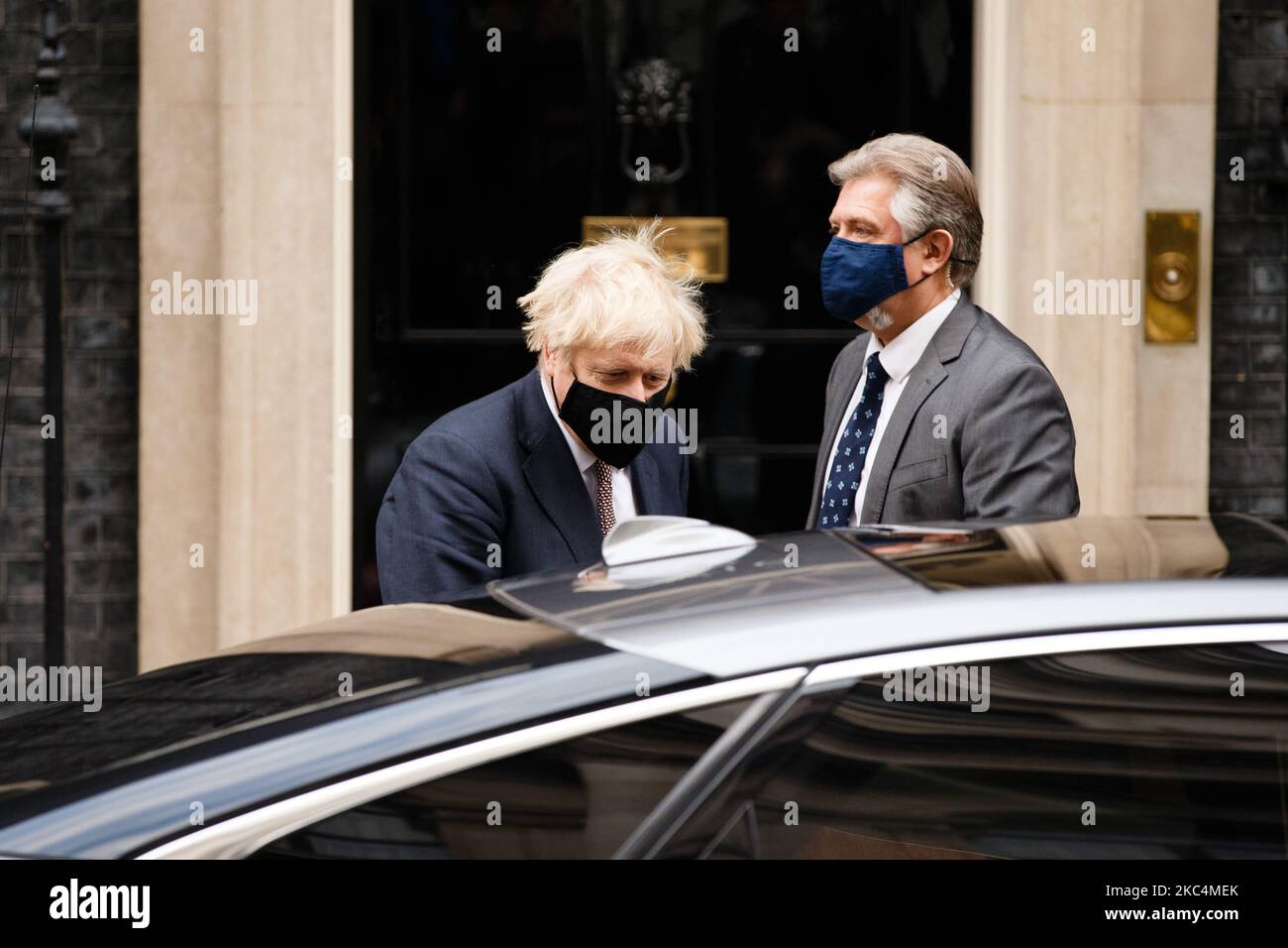 British Prime Minister Boris Johnson, Conservative Party leader and MP for Uxbridge and South Ruislip, wears a face mask leaving 10 Downing Street in London, England, on November 26, 2020. Johnson has been self-isolating for the last two weeks following notification by the National Health Service's 'track and trace' programme of contact at a Downing Street function with a fellow Conservative Party MP who later tested positive for coronavirus. The government is today meanwhile announcing which of the three 'tiers' of covid-19 restrictions will apply to local authorities across England at the en Stock Photo