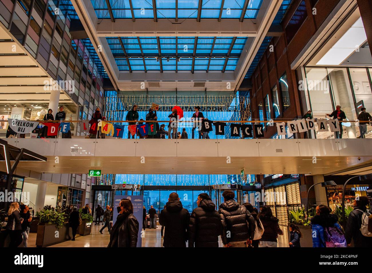 A few climate activists hold a banner against Black Friday inside the shopping mall before security guards removed it, during the 'Circus protest' against Black Friday, in Utrecht, on November 27th, 2020. (Photo by Romy Arroyo Fernandez/NurPhoto) Stock Photo