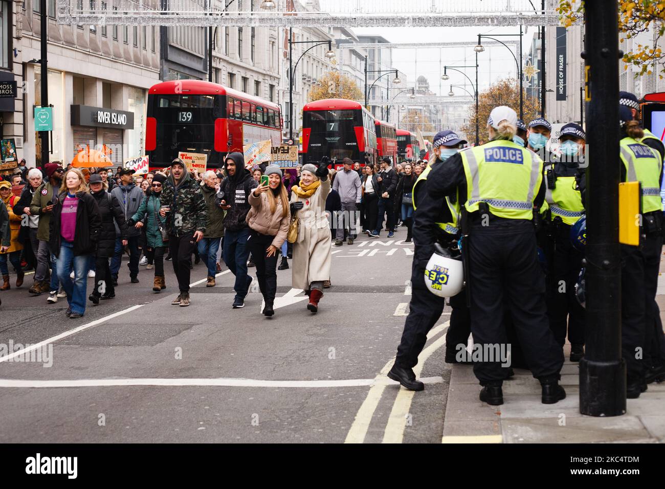 Anti-lockdown activists march along Oxford Street in London, England, on November 28, 2020. In an evening update the Metropolitan Police announced it had made 155 arrests over the course of the day's demonstrations, for offences including breaches of coronavirus regulations, assault on police and possession of drugs. London is to return to 'Tier 2' or 'high alert' covid-19 restrictions once the current England-wide coronavirus lockdown ends next Wednesday. All three of the tiers, assigned to local authorities across England, have been strengthened since the lockdown began on November 5, howeve Stock Photo