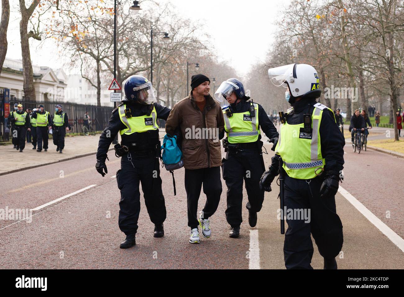 An anti-lockdown activist is arrested on Birdcage Walk during a demonstration in London, England, on November 28, 2020. In an evening update the Metropolitan Police announced it had made 155 arrests over the course of the day's demonstrations, for offences including breaches of coronavirus regulations, assault on police and possession of drugs. London is to return to 'Tier 2' or 'high alert' covid-19 restrictions once the current England-wide coronavirus lockdown ends next Wednesday. All three of the tiers, assigned to local authorities across England, have been strengthened since the lockdown Stock Photo