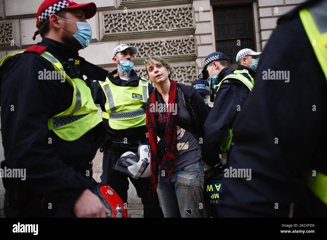 An anti-lockdown activist is arrested during a demonstration in London, England, on November 28, 2020. In an evening update the Metropolitan Police announced it had made 155 arrests over the course of the day's demonstrations, for offences including breaches of coronavirus regulations, assault on police and possession of drugs. London is to return to 'Tier 2' or 'high alert' covid-19 restrictions once the current England-wide coronavirus lockdown ends next Wednesday. All three of the tiers, assigned to local authorities across England, have been strengthened since the lockdown began on Novembe Stock Photo