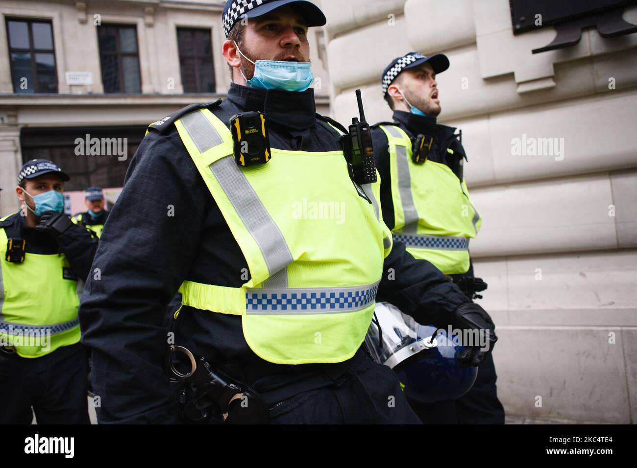 Police officers in riot gear march along Regent Street during an anti-lockdown demonstration in London, England, on November 28, 2020. In an evening update the Metropolitan Police announced it had made 155 arrests over the course of the day's demonstrations, for offences including breaches of coronavirus regulations, assault on police and possession of drugs. London is to return to 'Tier 2' or 'high alert' covid-19 restrictions once the current England-wide coronavirus lockdown ends next Wednesday. All three of the tiers, assigned to local authorities across England, have been strengthened sin Stock Photo