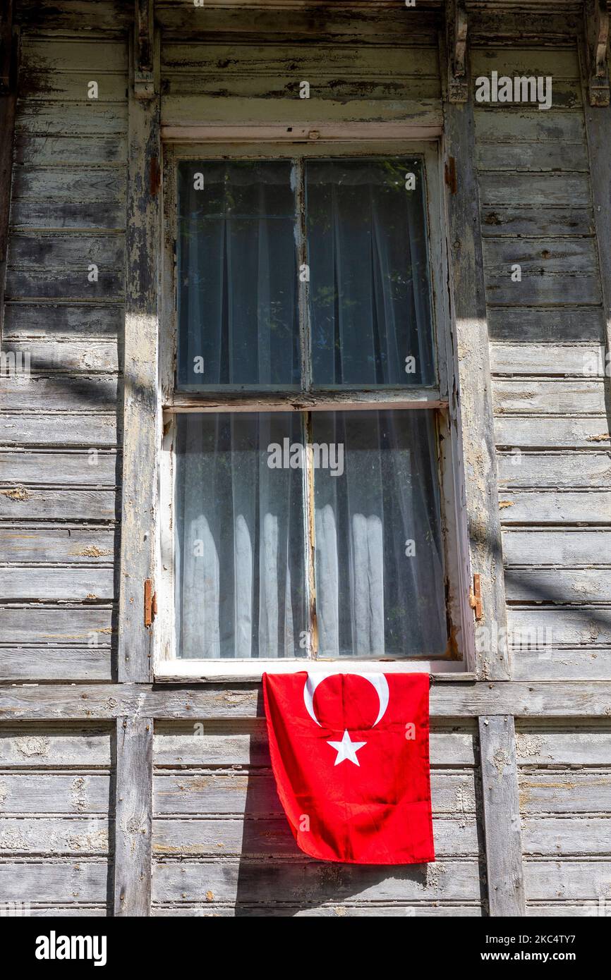 Turkish flag outside an old, wooden mansion house in Buyukada island (Prinkipos or Prinkipo) in the Sea of Marmara, near Istanbul, Turkey. Stock Photo