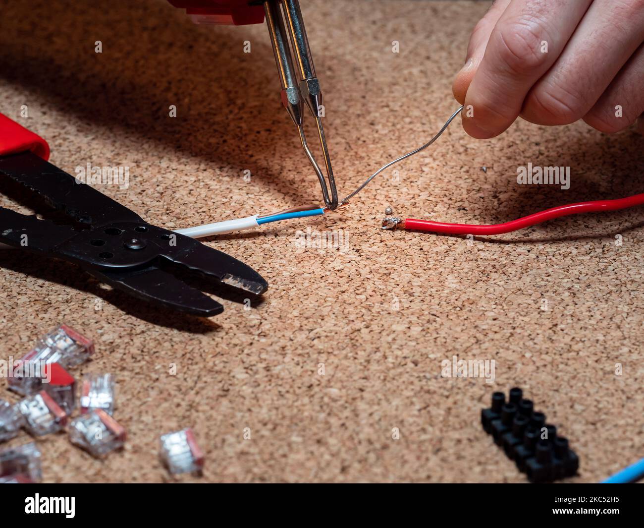 soldering connecting wires with tin and soldering iron, in