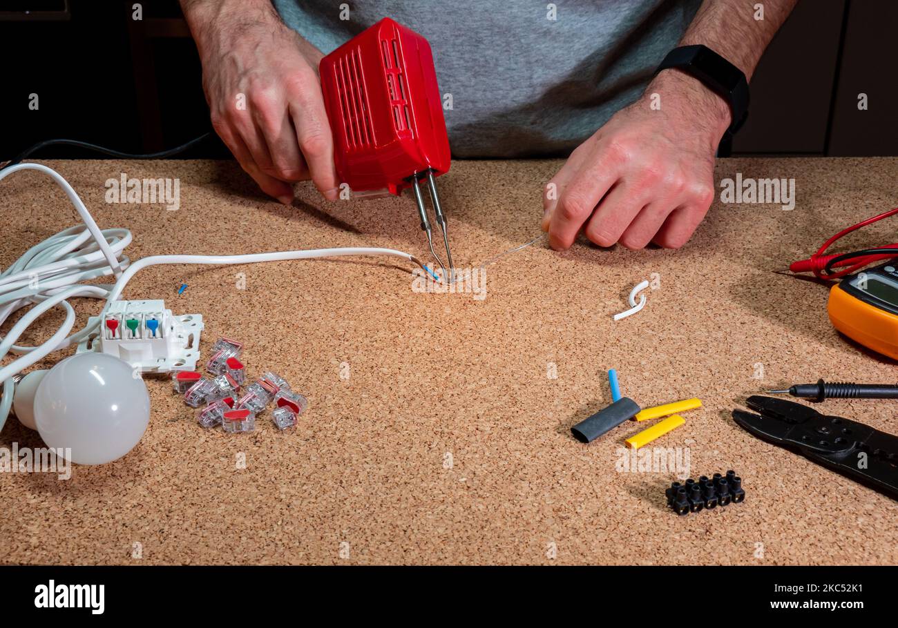 soldering connecting wires with tin and soldering iron, in