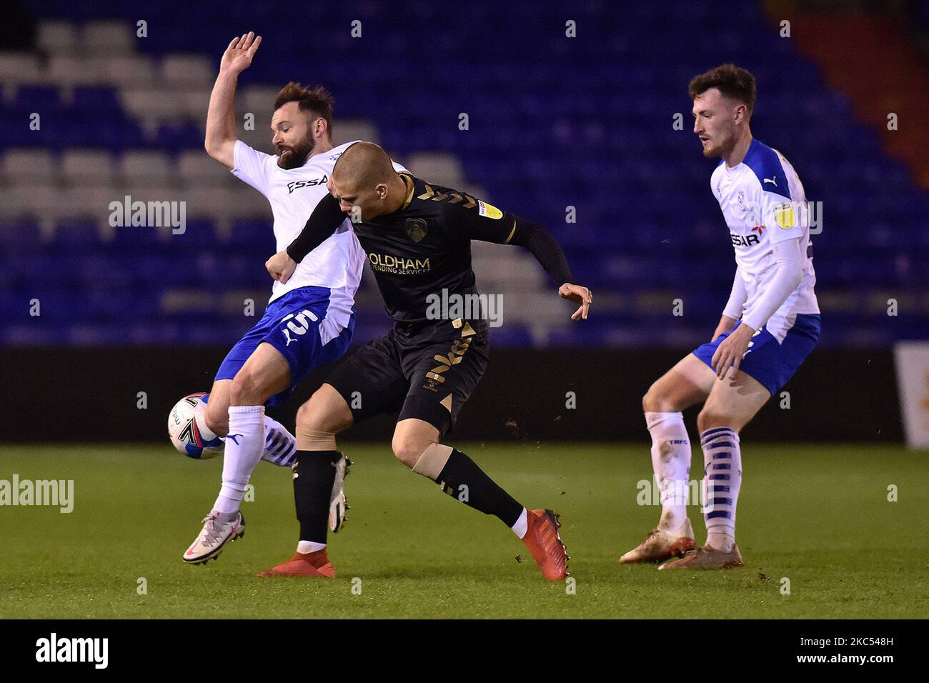 Oldham Athletic's Harry Clarke clears from Tranmere Rovers' Danny Lloyd and Tranmere Rovers' Paul Lewis during the Sky Bet League 2 match between Oldham Athletic and Tranmere Rovers at Boundary Park, Oldham on Tuesday 1st December 2020. (Photo by Eddie Garvey/MI News/NurPhoto) Stock Photo